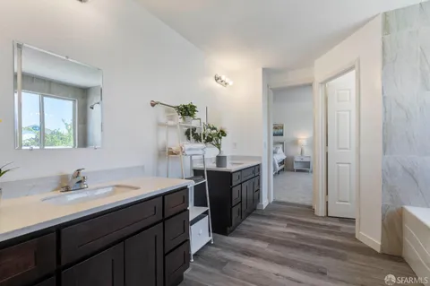 a spacious bathroom with a double vanity sink and a mirror