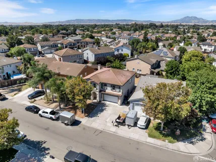 an aerial view of multiple houses with a yard