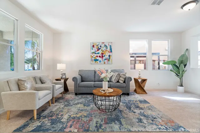 a living room with furniture wooden floor and a large window