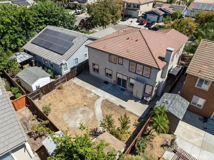 an aerial view of a house with a yard and balcony