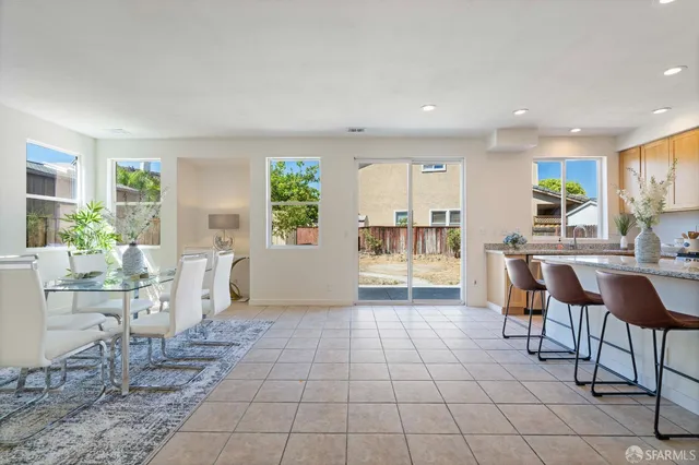 a view of kitchen with furniture and refrigerator