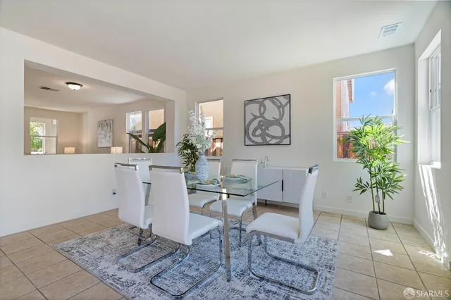 a living room with furniture and flowers
