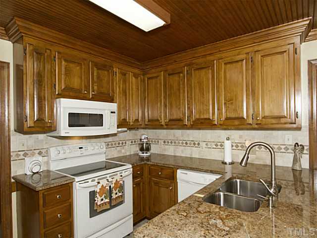 2812 Halfhitch Trail Raleigh, NC 27615 - Photo 7 of 23 Granite countertops, under counter sink, updated fixtures, smooth top range, built-in microwave.