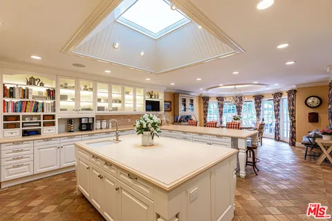 a kitchen with stainless steel appliances granite countertop a stove and a refrigerator