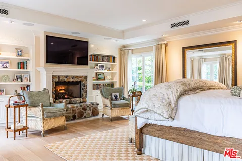 a bedroom with a bed and a flat screen tv