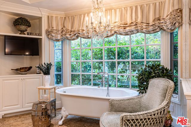 a living room filled with furniture and a flat screen tv