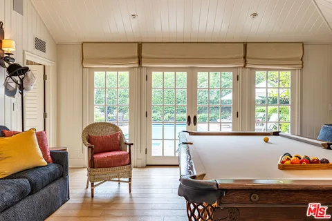 a living room with furniture a rug and a large window