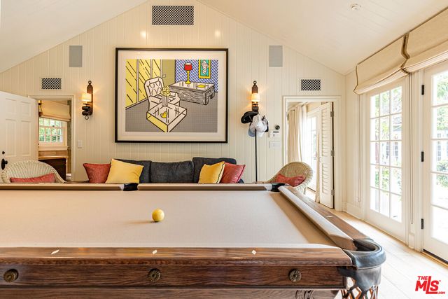 a living room with furniture a chandelier and a dining table