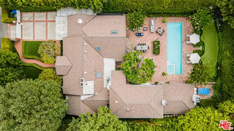 a view of a swimming pool with a garden and plants
