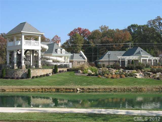 9006 Rochedale Place, Unit 73 Waxhaw, NC 28173 - Photo 4 of 4 a front view of a house with a garden and plants