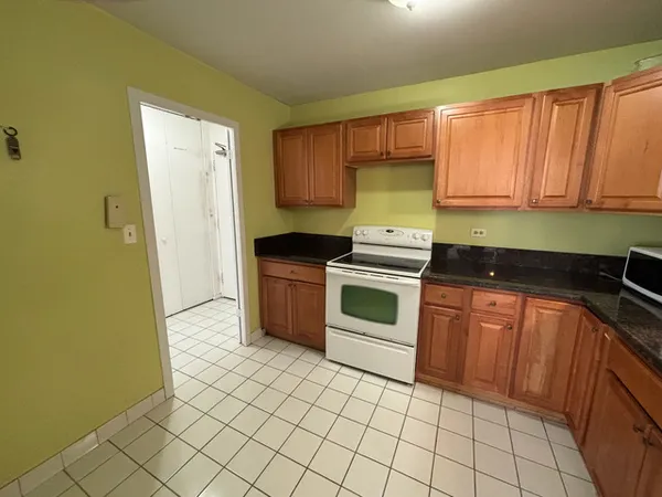 a kitchen with stainless steel appliances a stove sink and cabinets