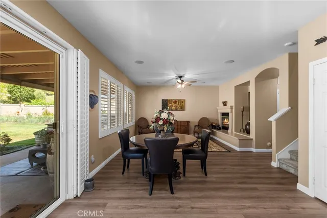 a bedroom with a bed a chandelier and a flat tv screen on dresser