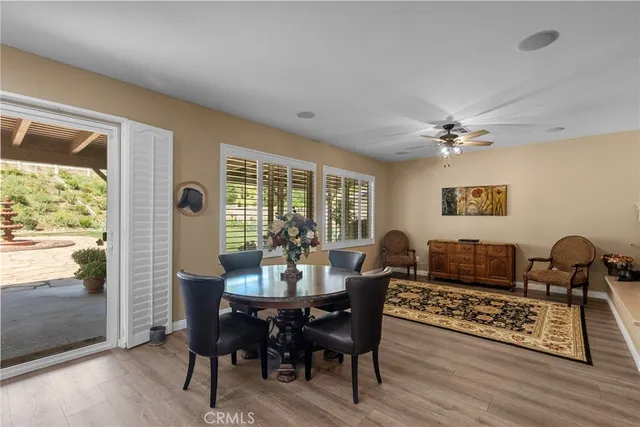 a bathroom with a granite countertop sink a large mirror a bathtub and next to a window