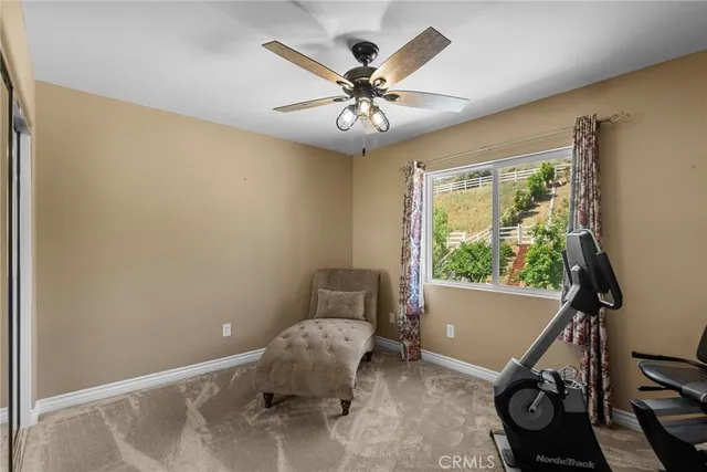a living room with patio furniture and garden
