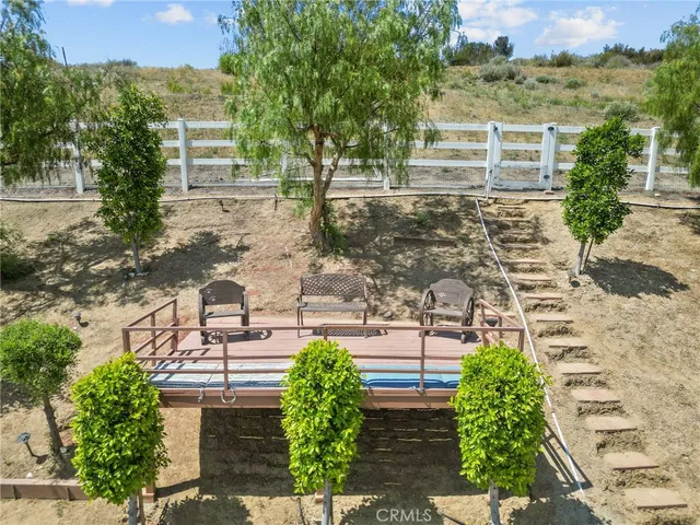 a view of a patio with table and chairs and potted plants