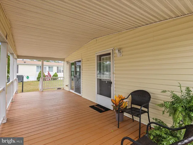 a view of a patio with table and chairs and potted plants