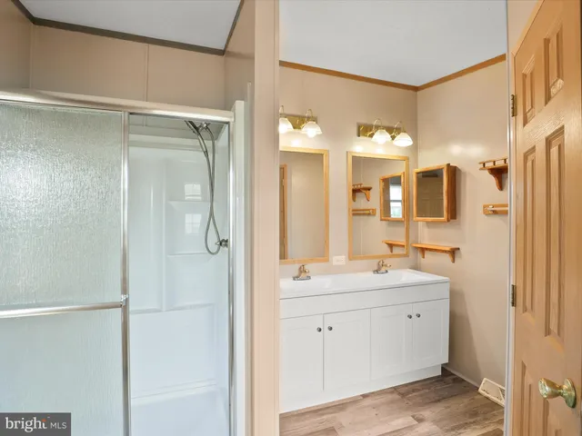 a spacious bathroom with a shower sink and mirror
