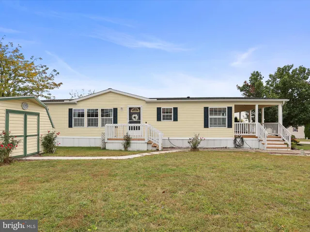 a front view of house with yard patio and green space