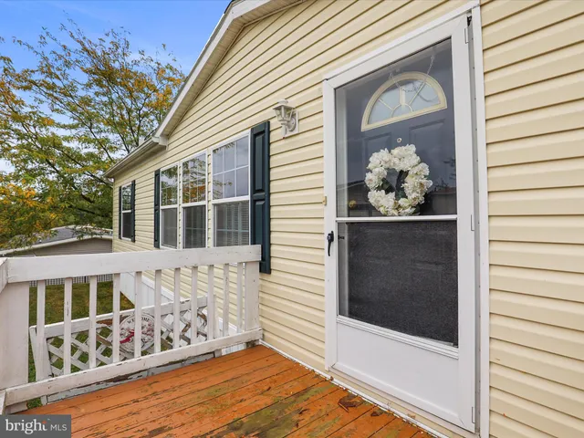 a front view of a house with wooden fence