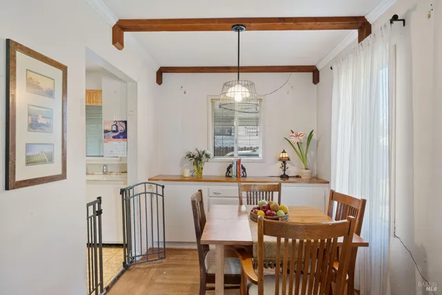 a view of a dining room with furniture and window