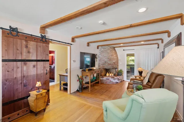 a living room with furniture a window and gym equipment