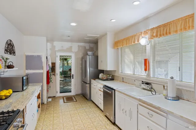 a living room with furniture and a lamp