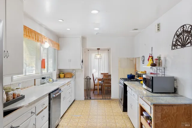 a view of a bedroom with workspace and a window