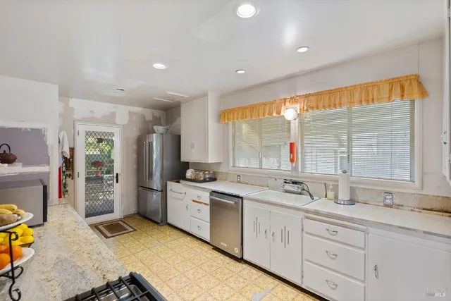 a kitchen with stainless steel appliances a sink and a cabinets