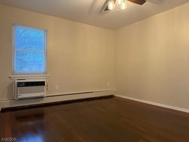 a room with a wooden floor and cabinetry