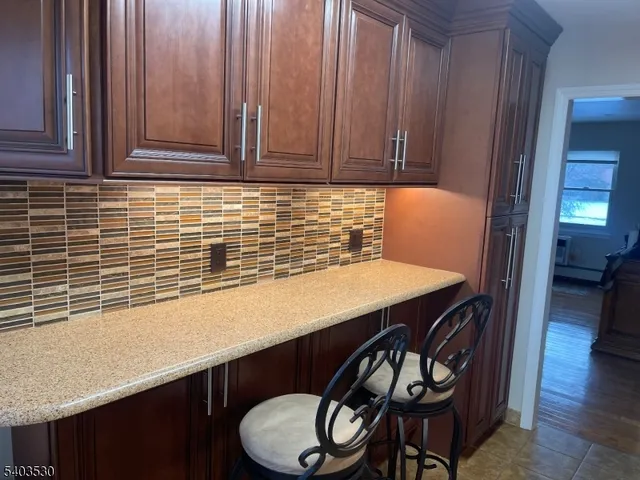 a kitchen with a table chairs and cabinets
