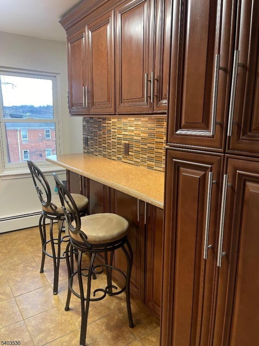1130 Valley Road, Unit 2A Wayne, NJ 07470 - Photo 4 of 19 a view of a chair and table in the kitchen