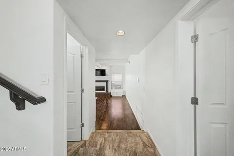 a view of hallway with wooden floor