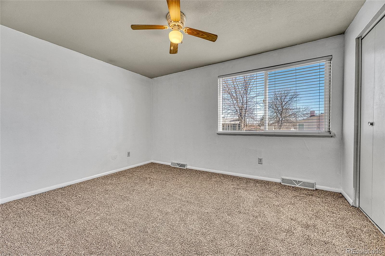 7461 Webster Street Arvada, CO 80003 - Photo 14 of 31 an empty room with windows