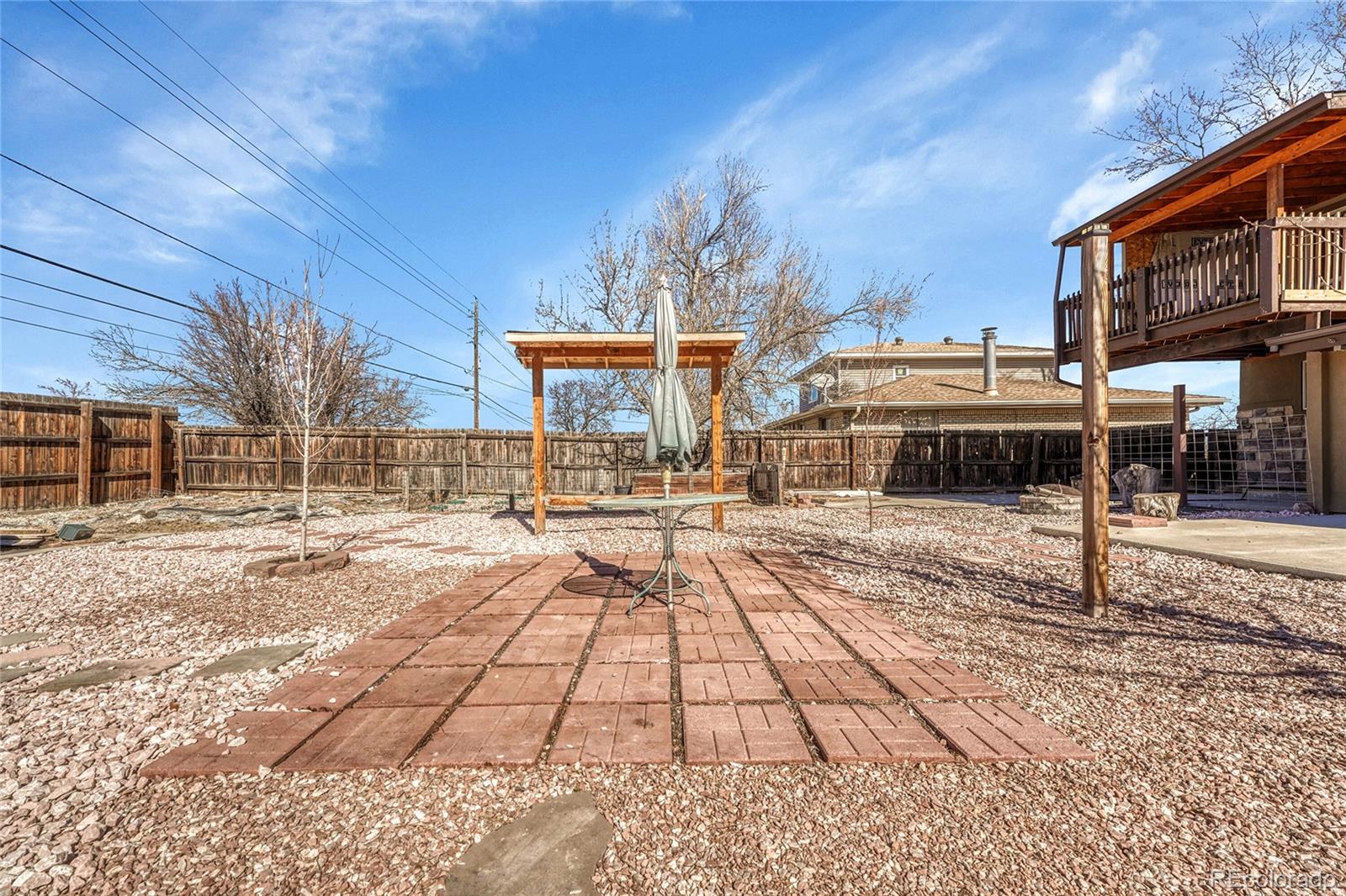 7461 Webster Street Arvada, CO 80003 - Photo 26 of 31 a view of a house with a yard