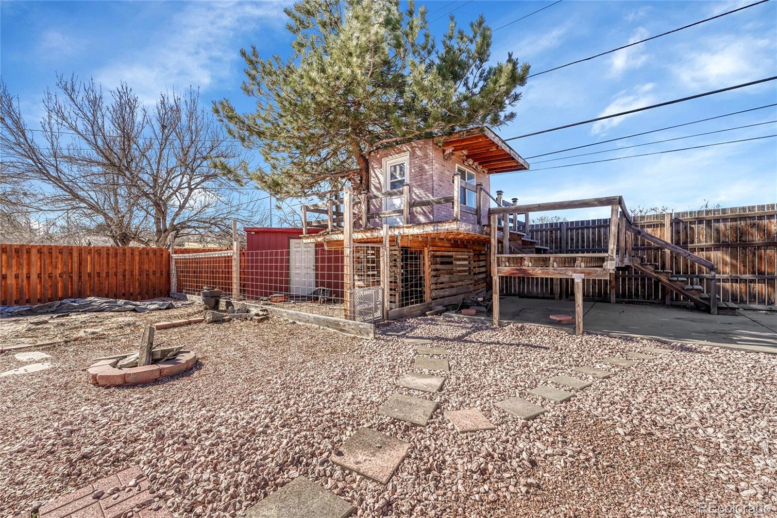 7461 Webster Street Arvada, CO 80003 - Photo 28 of 31 a backyard of a house with barbeque oven table and chairs