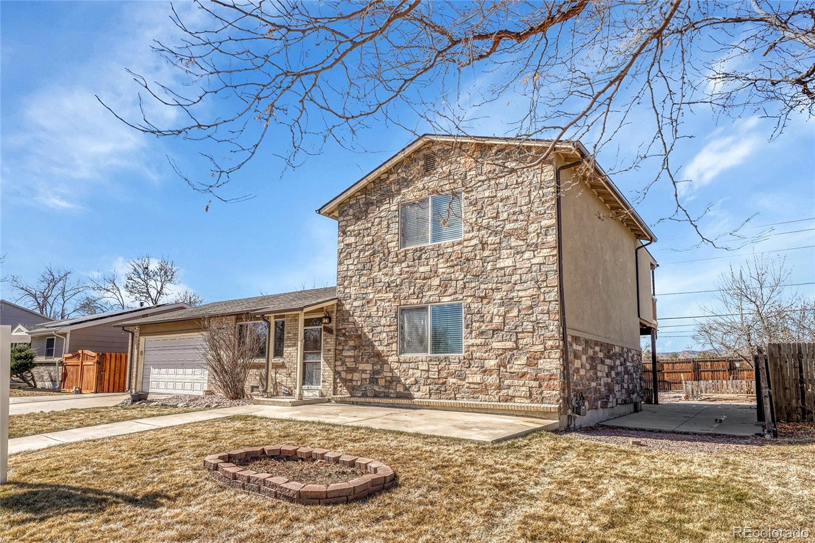 7461 Webster Street Arvada, CO 80003 - Photo 3 of 31 a front view of a house with a yard