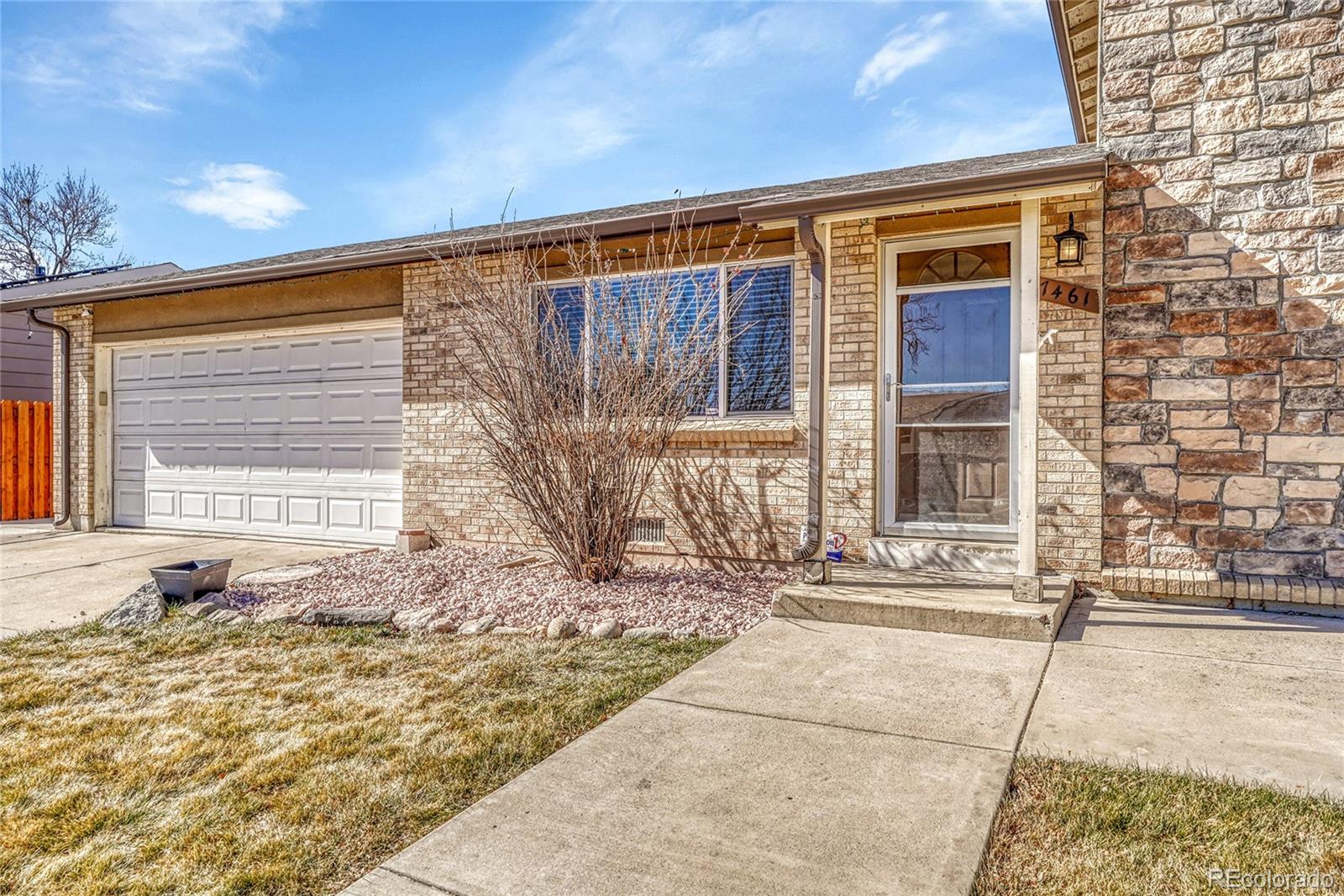 7461 Webster Street Arvada, CO 80003 - Photo 4 of 31 a front view of a house with a yard