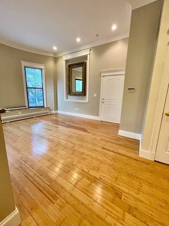 13 Worcester Square, Unit 2 Boston, MA 02118 - Photo 9 of 16 a view of an empty room with wooden floor and a window