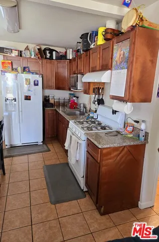 a large bed sitting in a bedroom next to a larger window