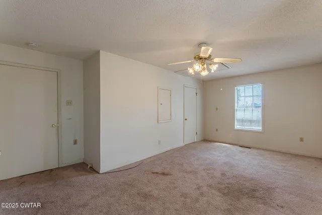 a bathroom with a granite countertop sink toilet and mirror