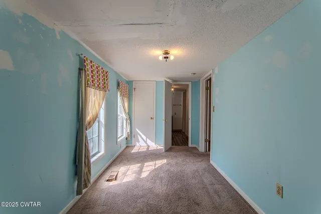 a front view of a house with a garden and parking space