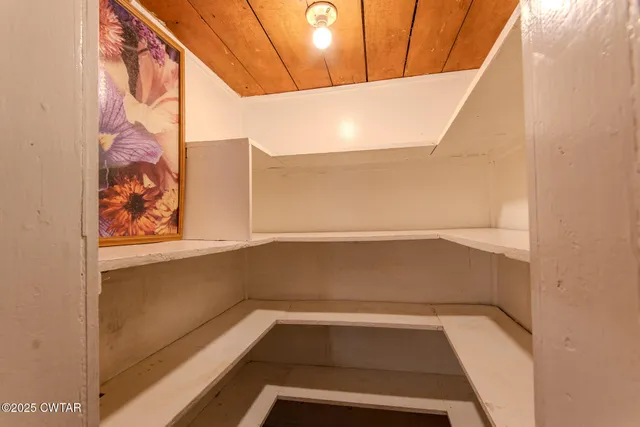 a view of n empty room with a window