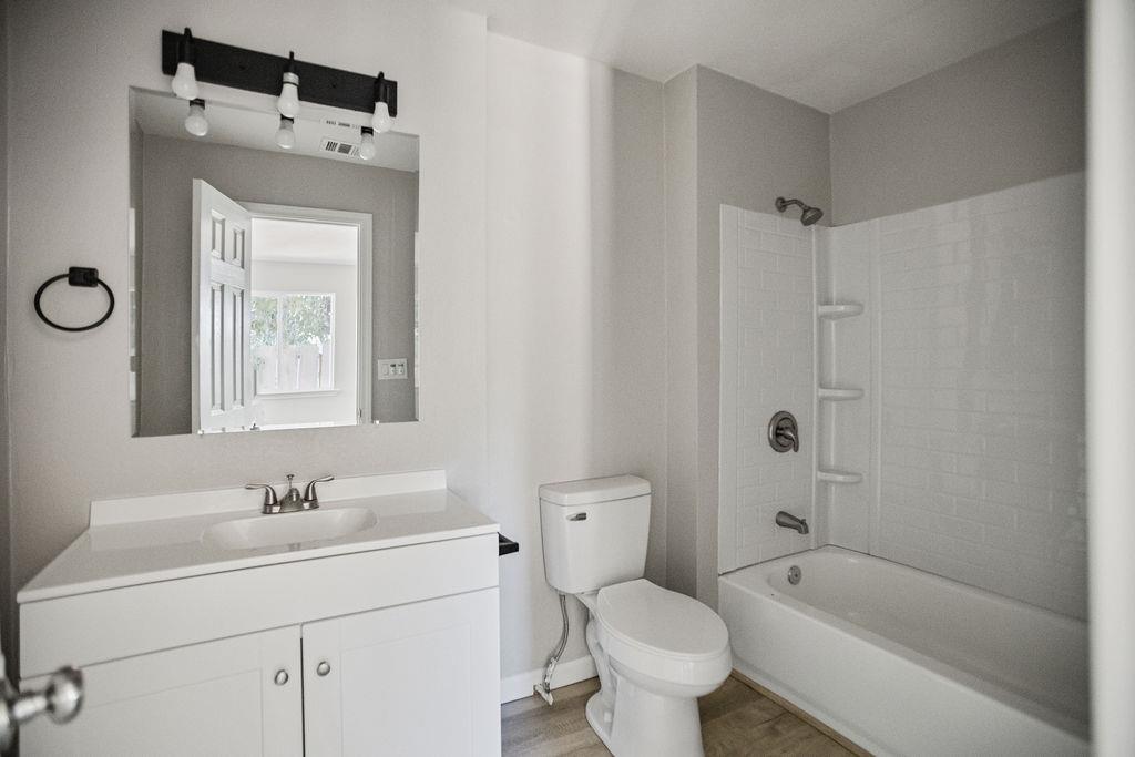 2525 R Street Merced, CA 95340 - Photo 10 of 12 a bathroom with a sink a toilet and shower