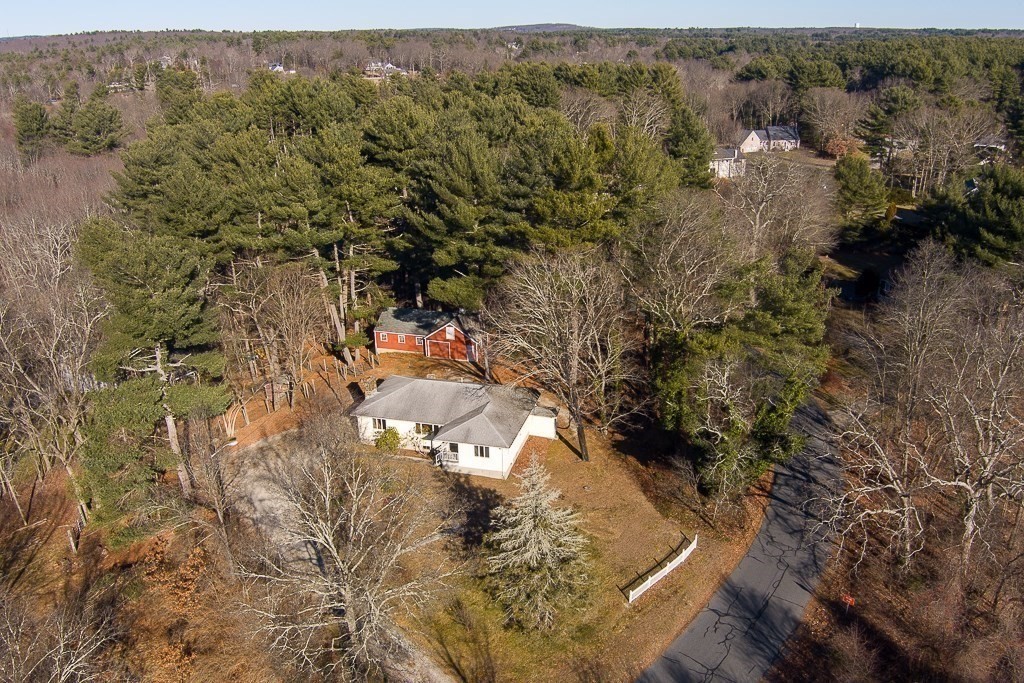 an aerial view of a house with a yard