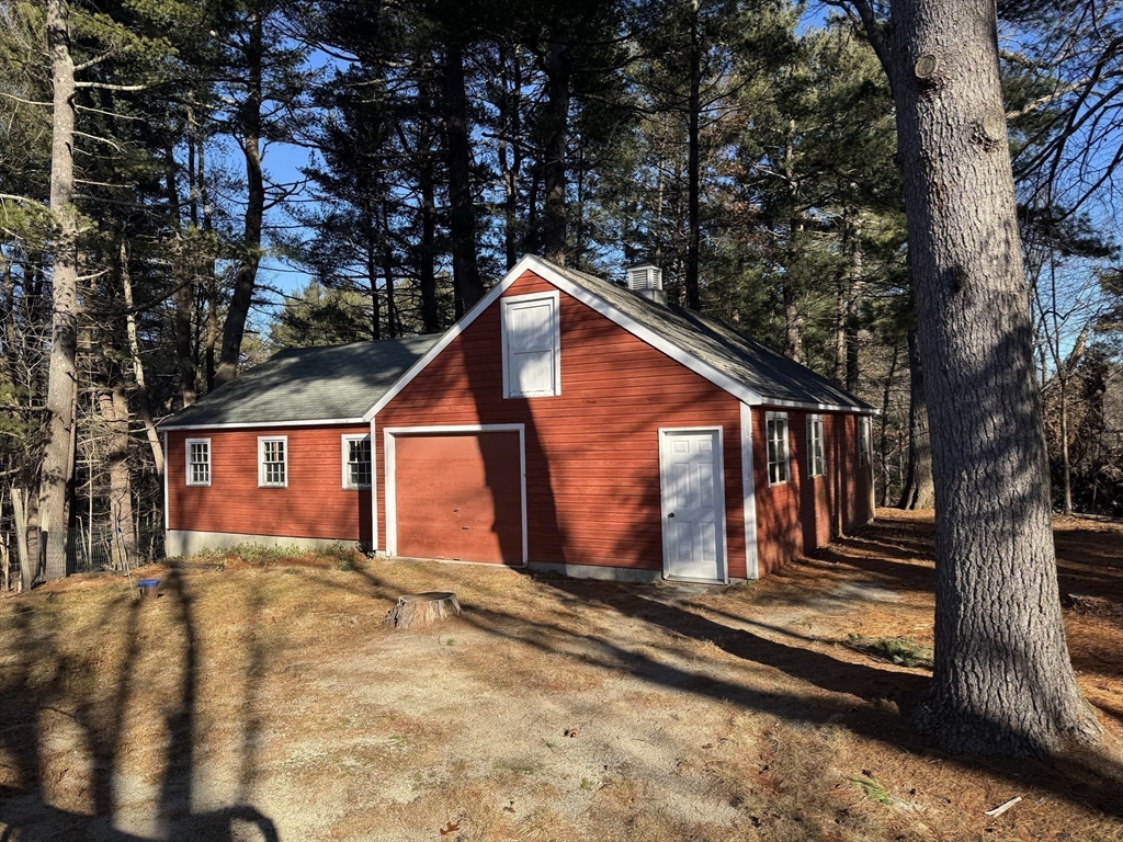 31 Cemetery Street Mendon, MA 01756 - Photo 23 of 39 a view of a house with large windows and a small yard