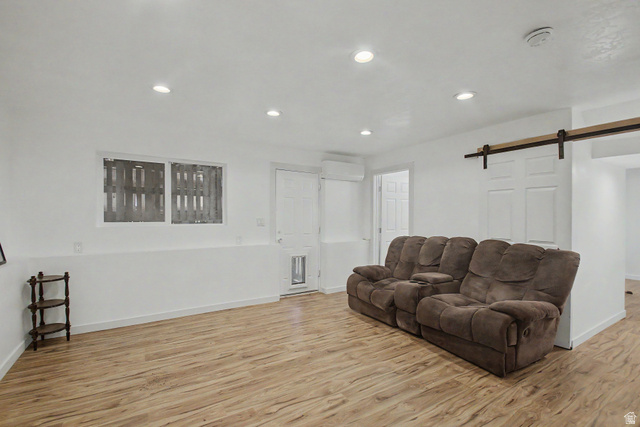 12645 East Cedar Ridge Drive Fairview, UT 84629 - Photo 26 of 34 Spacious room featuring wood-finish flooring, recessed lighting, and a barn door entry