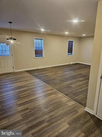 a view of a room with wooden floor