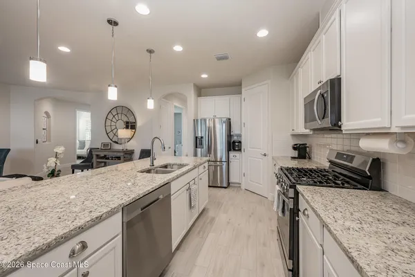a kitchen with a sink stove and cabinets