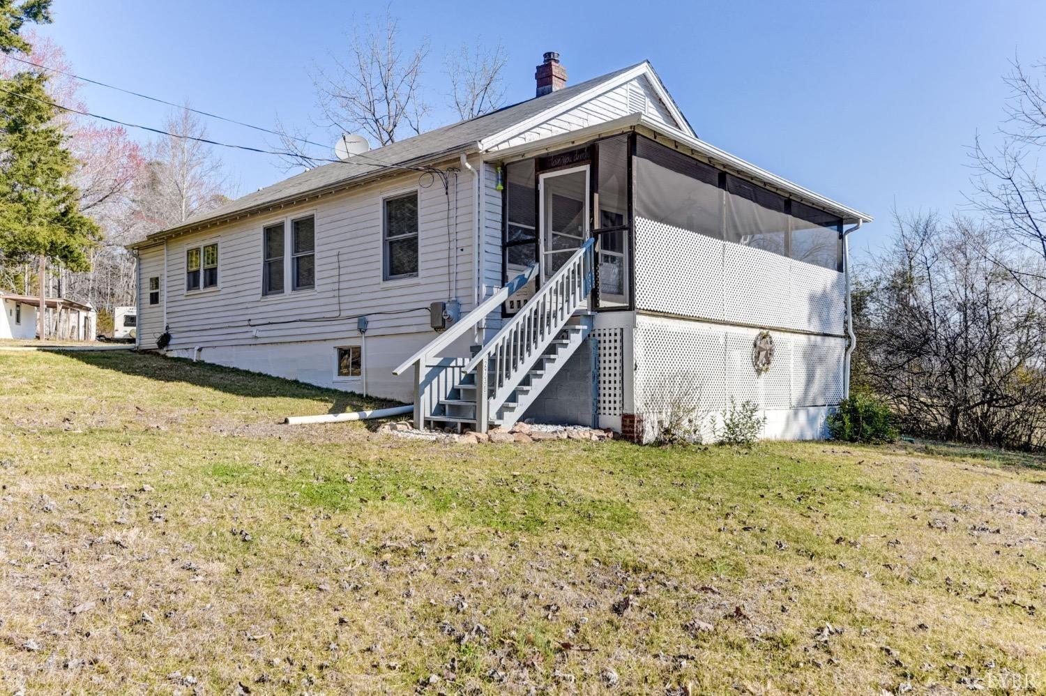 2730 New Chapel Road Rustburg, VA 24588 - Photo 1 of 31 a house with tall trees in the background
