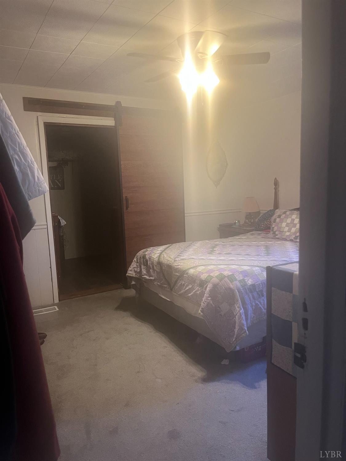 2730 New Chapel Road Rustburg, VA 24588 - Photo 20 of 31 a bedroom with a bed and a table in it